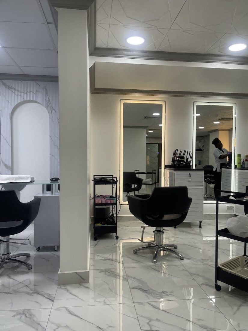 Inside Nice Flower Ladies Beauty Saloon: salon chairs, lit mirrors and a marble wall